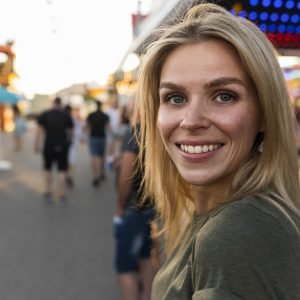 close-up-smiley-woman-posing-outside